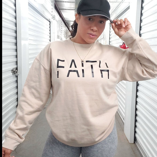 Faith crewneck sweater with bold script, featuring a minimalist design symbolizing unwavering belief in God.