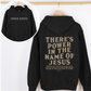 Black hoodie with the message "There's power in the name of Jesus" 